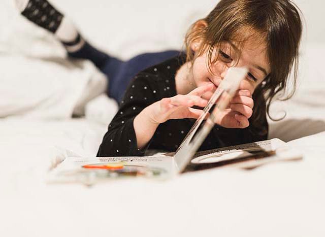 Young child reading childrens book