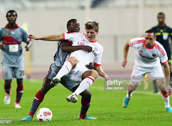 DOHA, QATAR - JANUARY 05: Toni Kroos of Muenchen is challenged by Tresor Kangambu of Lekhwiya during the international friendly match between Lekhwiya Sports Club and FC Bayern Muenchen at Khalifa International Stadium on January 5, 2013 in Doha, Qatar. (Photo by Alex Grimm/Bongarts/Getty Images)